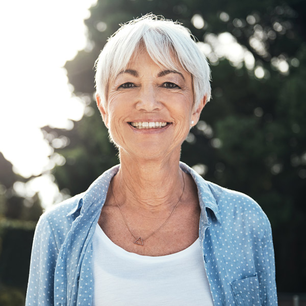 mature woman in blue shirt smiling