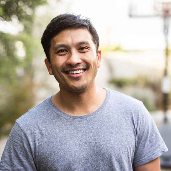 man in gray shirt smiling