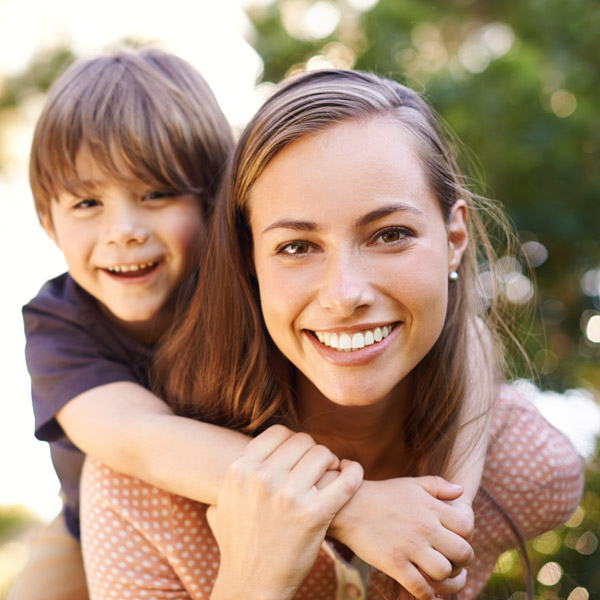 mother and son outdoors smiling