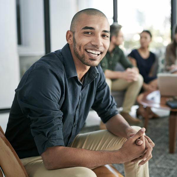young man in professional attire smiling