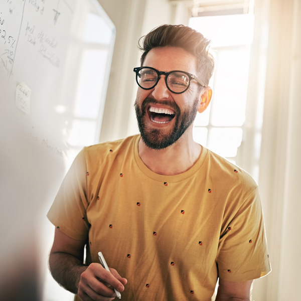 young man in glasses smiling